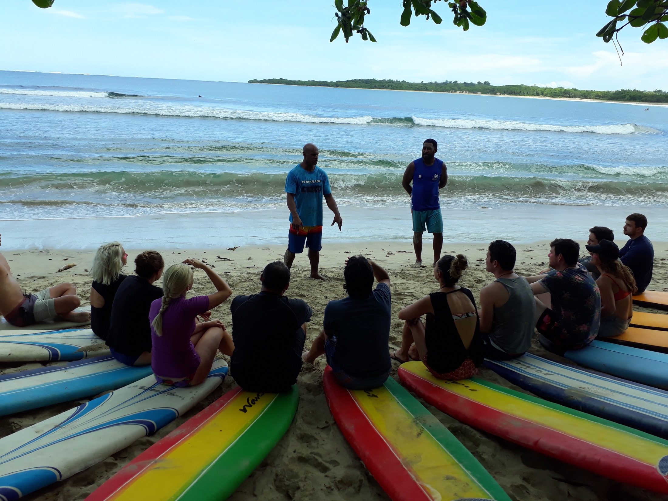 Inia teaching a surf group on the beach in Fiji