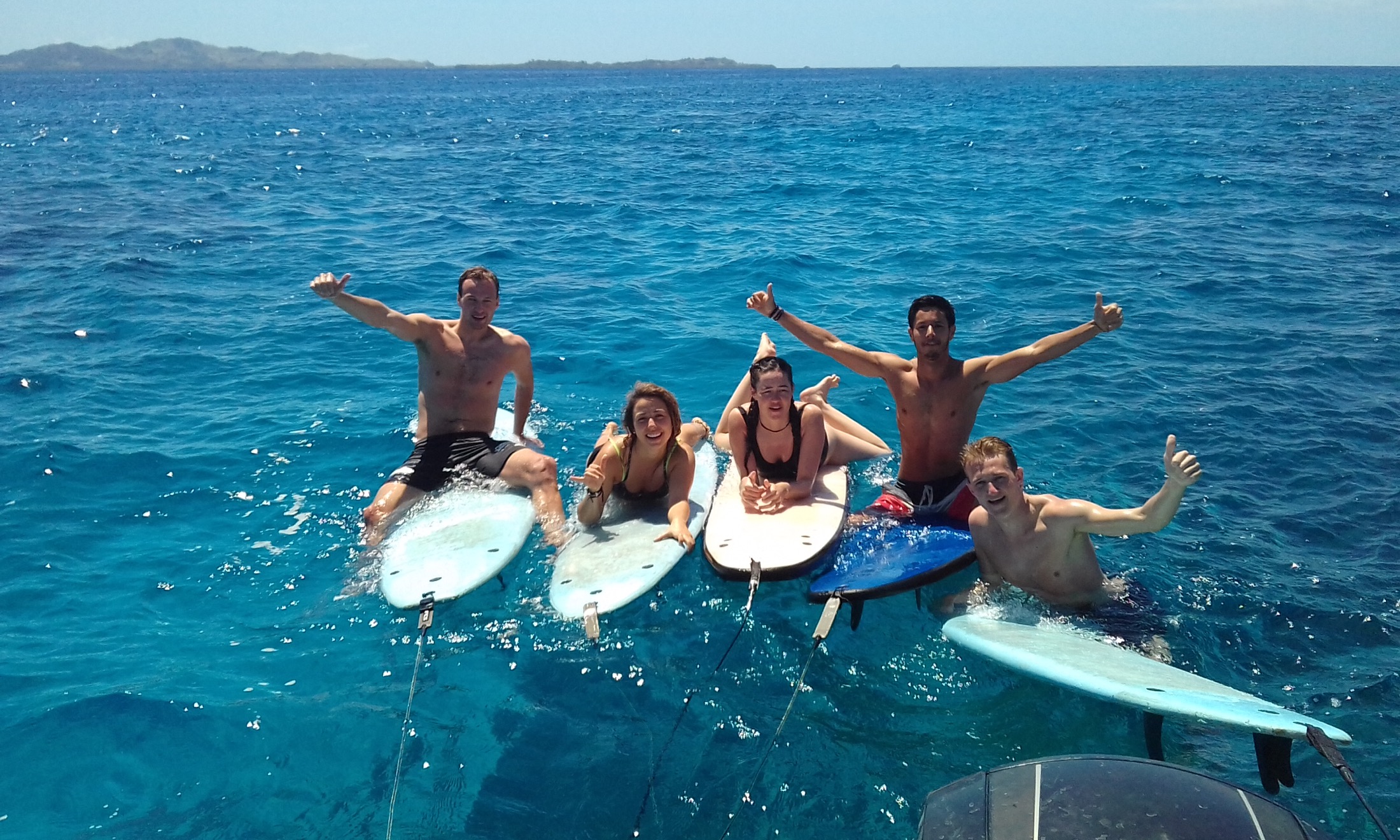 Dream Surf Fiji guests floating on surfboards in clear blue water