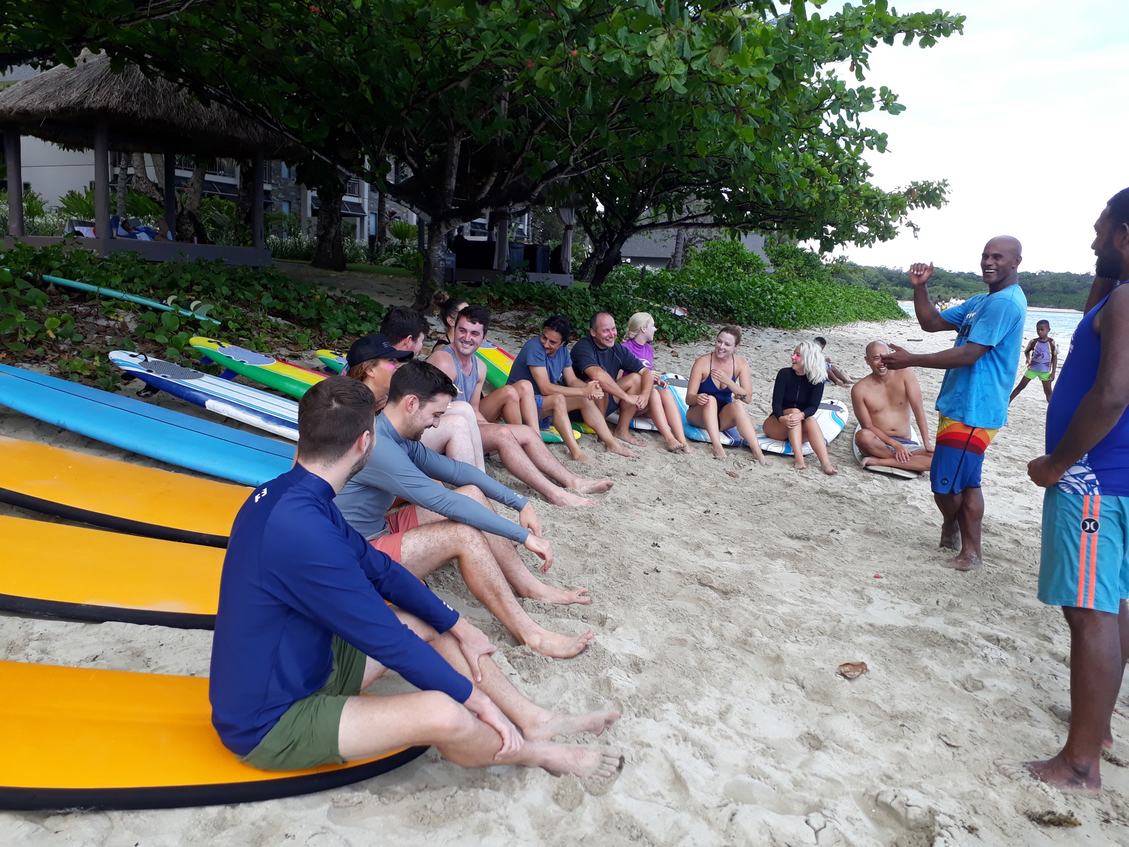 Inia speaking with Dream Surf Fiji guests on the beach