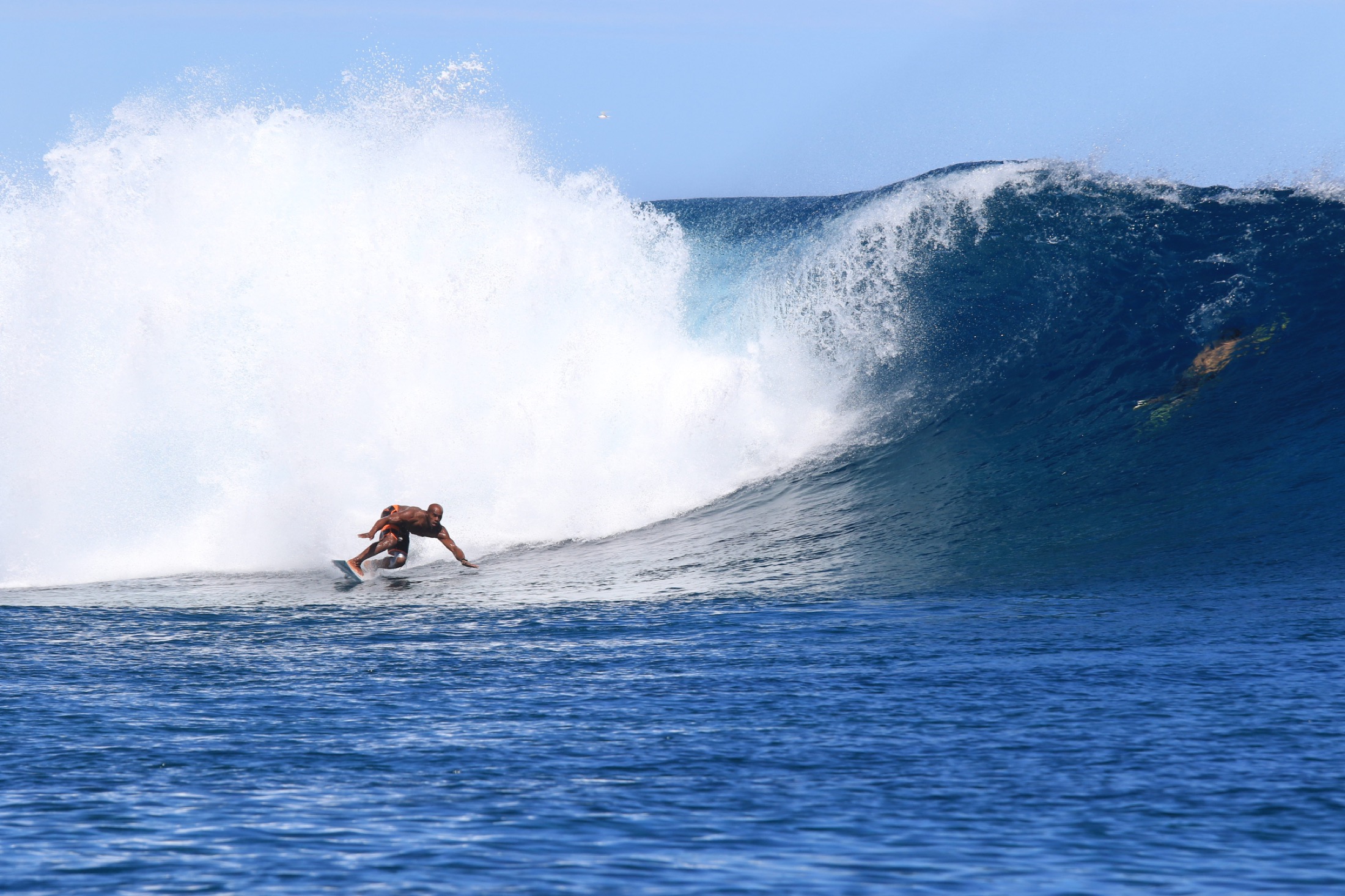 Inia surfing a powerful Fiji reef wave